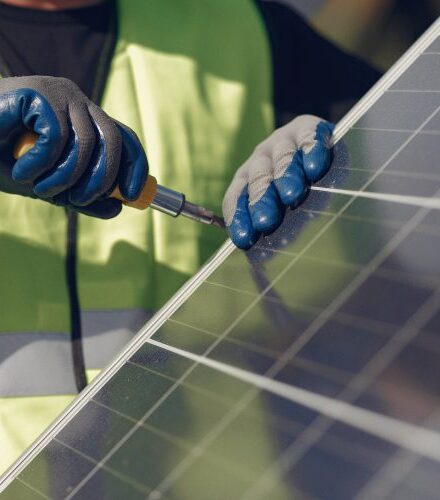 man-with-white-helmet-near-solar-panel-770x500